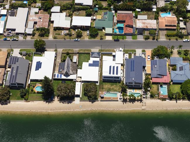 Solar panels on suburban waterfront homes.