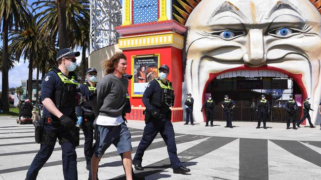 Police detain a protester at the front of Luna Park. Picture: William West