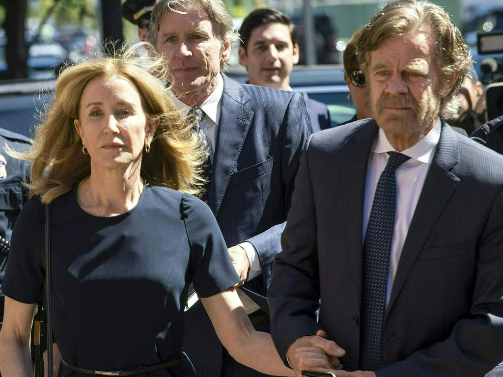 Huffman, escorted by her husband William H. Macy, makes her way to the entrance of the court. Picture: Joseph Prezioso/AFP