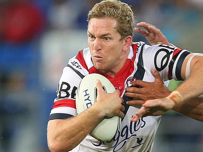 GOLD COAST, AUSTRALIA - MAY 16: Mitchel Aubusson of the Roosters is tackled during the round 10 NRL match between the Gold Coast Titans and the Sydney Roosters at Cbus Super Stadium on May 16, 2016 on the Gold Coast, Australia. (Photo by Chris Hyde/Getty Images)