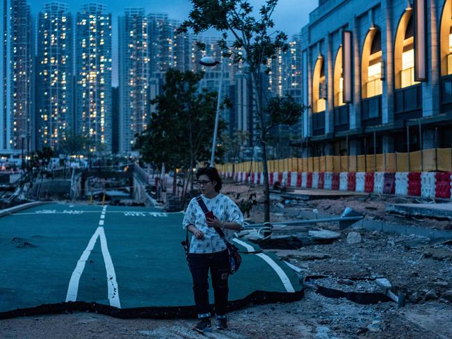 A woman walks along a ruined cycling path destroyed by Typhoon Mangkhut in Tseung Kwan O district in Hong Kong. Picture: AFP