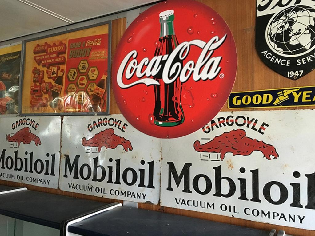 A Coca-Cola and Mobil Oil advertising on sale.