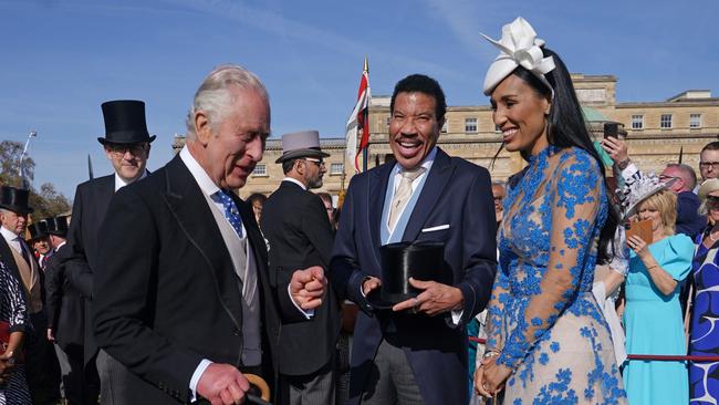 King Charles III speaks to Lionel Richie and Lisa Parigi during the pre-coronation garden party at Buckingham Palace on Thursday. Picture: Getty Images