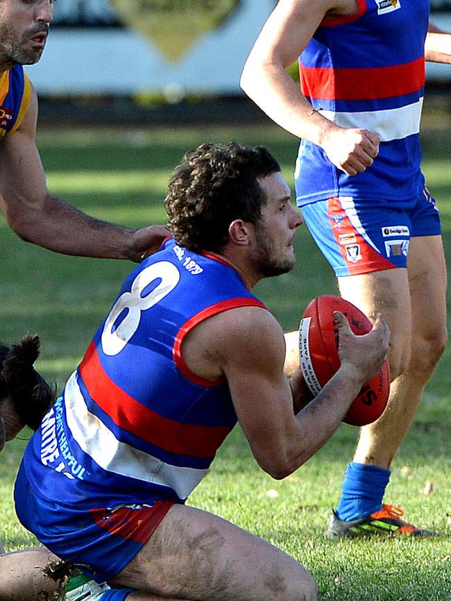 Casey Summerfield gathers possession at ground level for Gisborne.