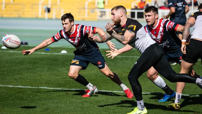 Luke Keary and Angus Crichton defend the left edge as former New Zealand Warriors fullback Sam Tomkins fires a pass for Catalans in Barcelona.