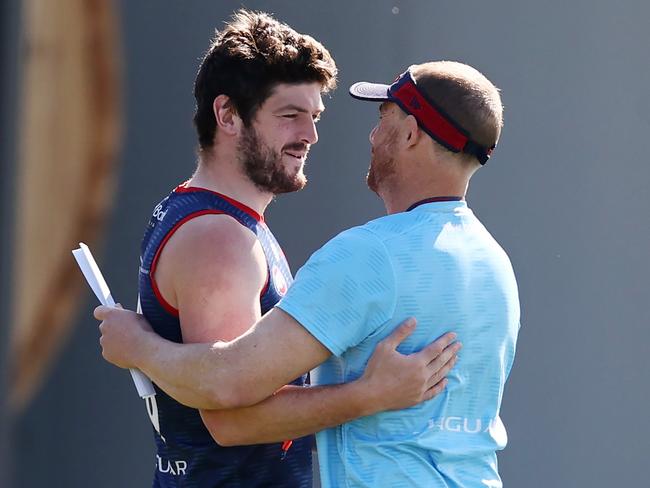 MELBOURNE, AUSTRALIA - September 11 , 2023. AFL.    Angus Brayshaw shakes hands with and hugs coach Simon Goodwin during Melbournes training session at Casey Fields, Cranbourne   Photo by Michael Klein.