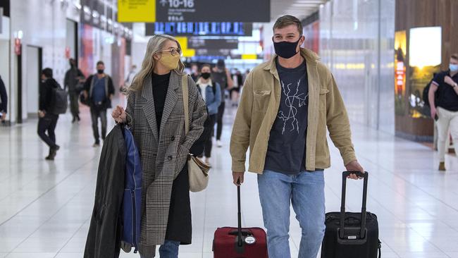 Ollie Wines and his partner Olivia May arrive home to Adelaide Airport from Perth on Monday, September 20. Picture: Mark Brake