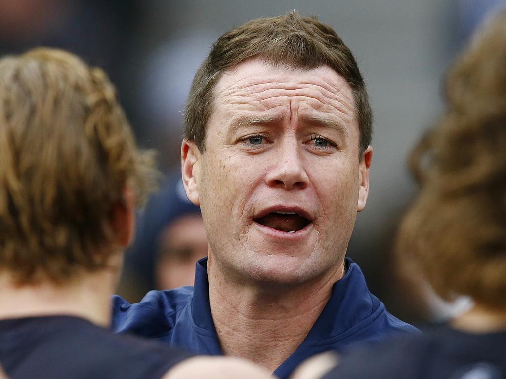 Barker addresses players during a clash with Collingwood in 2015.