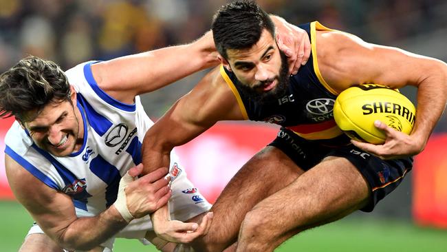 Jarrad Waite of the Kangaroos tackles Wayne Milera of the Crows.