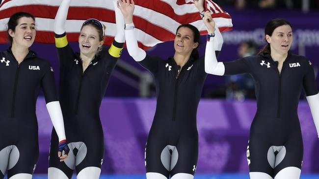 Bronze medallist team U.S.A. with Carlijn Schoutens, Mia Manganello, Brittany Bowe and Heather Bergsma, from left to right, celebrate after the women's team pursuit speed skating race at the Gangneung Oval at the 2018 Winter Olympics in Gangneung, South Korea, Wednesday, Feb. 21, 2018. (AP Photo/Petr David Josek)