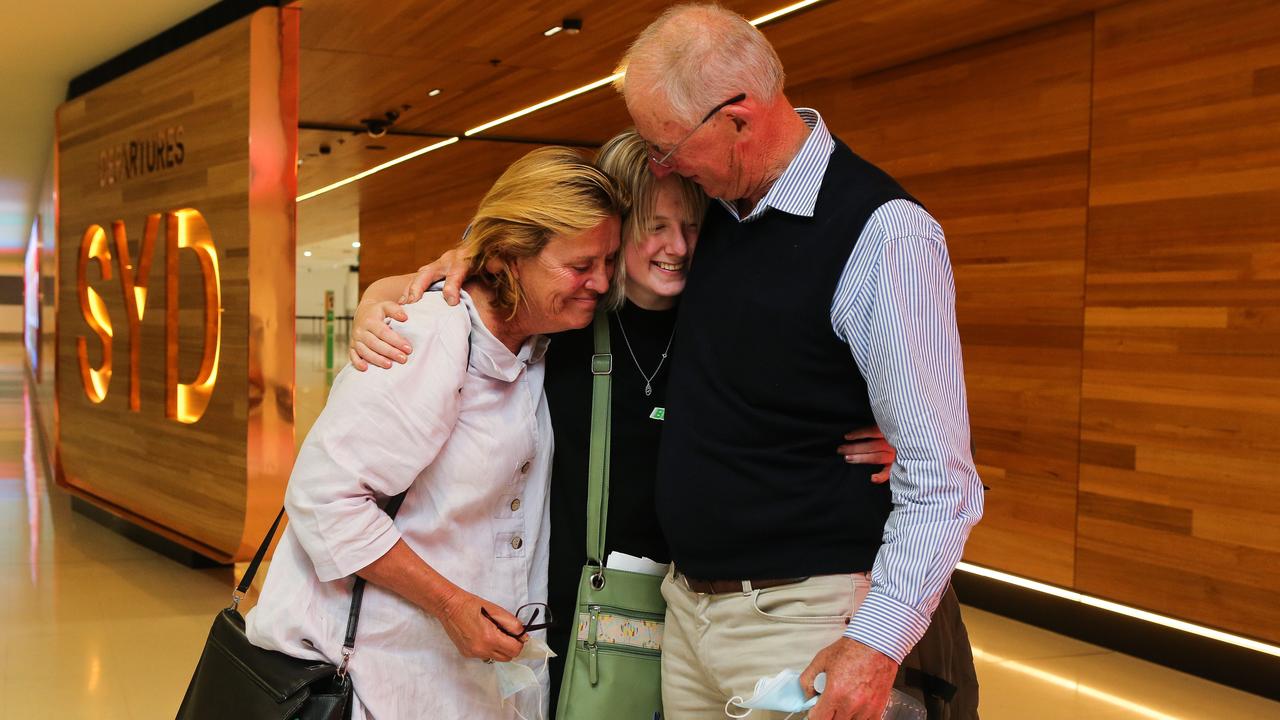 Fiona Robertson and Bruce Robertson with their daughter Elle Robertson at the International Terminal at Sydney Airport to as Elle prepares to depart on the first flight out to London with Qantas since Covid restrictions have lifted in Sydney. Picture: NCA Newswire / Gaye Gerard