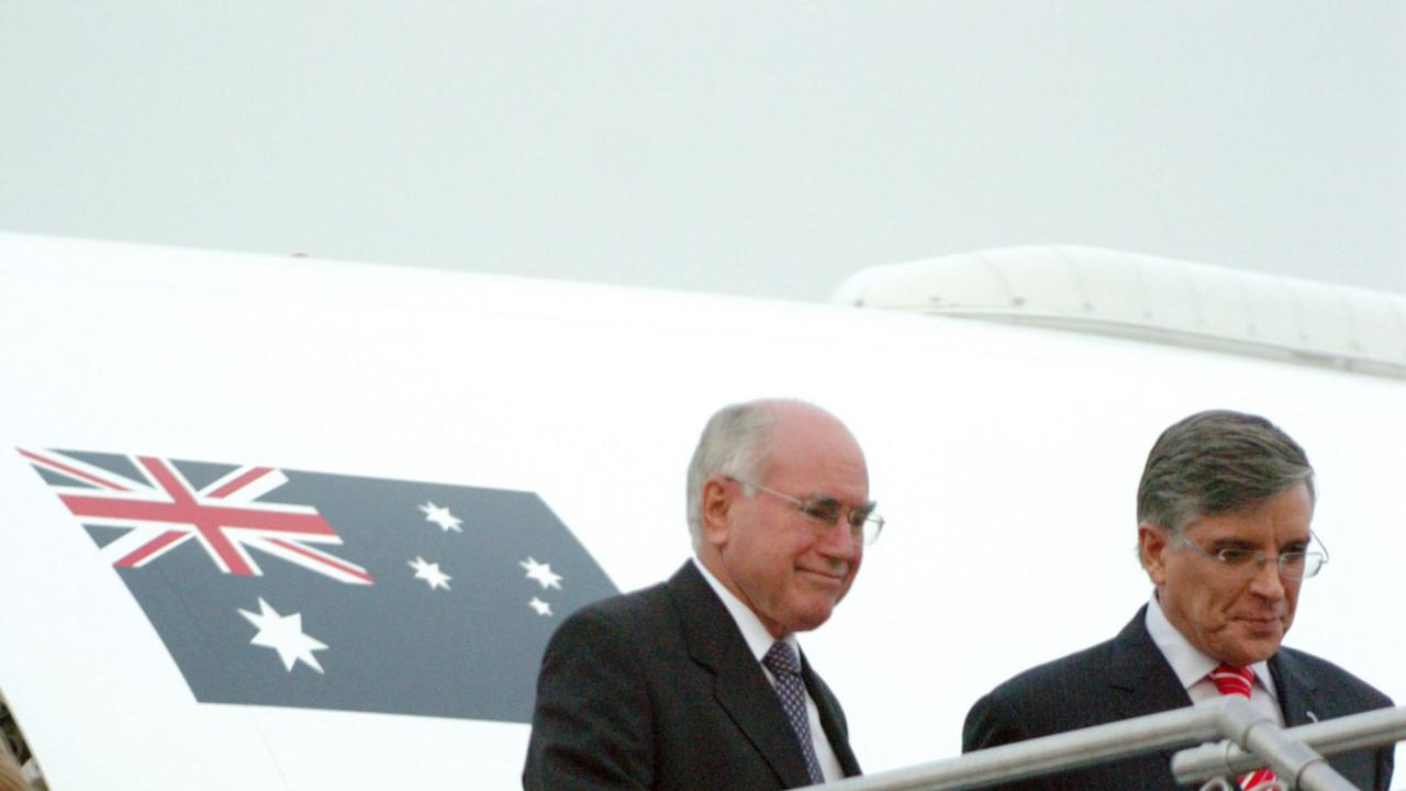 Prime Minister John Howard with wife Janette are meet by Australian Ambassador to Vietnam Bill Tweddell, as exit their aircraft at airport after they arrived in Vietnamese capital Hanoi for APEC Summit.