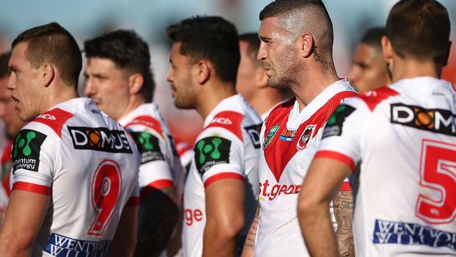 Dragons players look on after conceding a try against the Newcastle Knights.