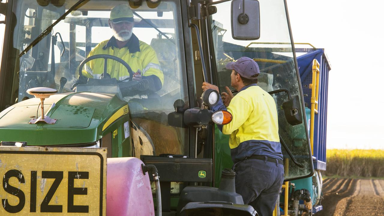 Sugar cane farmer Joseph Lizzio, of MSF Sugar, checks the soil in one of his cane paddocks at Silkwood south of Cairns then gives instructions to tractor driver Alan Cross. Picture: Brian Cassey