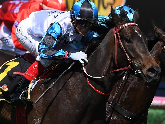 Jockey Craig Williams (left) rides Amphitrite to victory in the Schweppes Thousand Guineas.