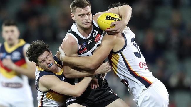 Ned McHenry and Darcy Fogarty bring down Port Adelaide’s Peter Ladhams in the SANFL qualifying final. Picture: SARAH REED