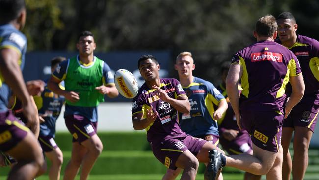 Anthony Milford (centre) in action during a Brisbane Broncos training session on Monday before being struck down by the virus. Picture: AAP