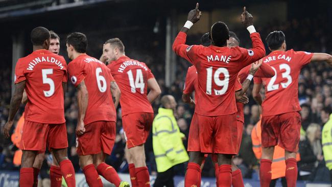 Liverpool's Senegalese midfielder Sadio Mane celebrates scoring his team's first goal during the English Premier League football match between Everton and Liverpool at Goodison Park in Liverpool, north west England on December 19, 2016. / AFP PHOTO / Oli SCARFF / RESTRICTED TO EDITORIAL USE. No use with unauthorized audio, video, data, fixture lists, club/league logos or 'live' services. Online in-match use limited to 75 images, no video emulation. No use in betting, games or single club/league/player publications. /