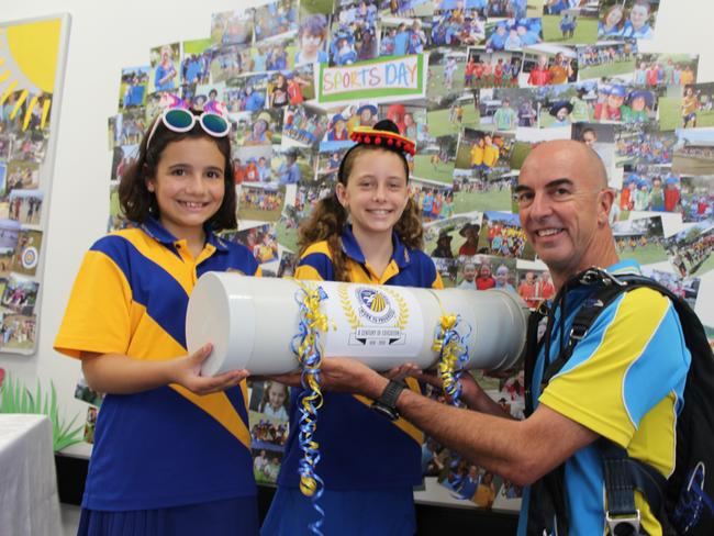 Coolangatta State School students Christian Faigane, Zoe Bird, Mia Joseph and Elissa Dudley talk to former student and Gold Coast Skydiving 'time capsule deliverer Archy Jamieson about the upcoming festivities this weekend. 