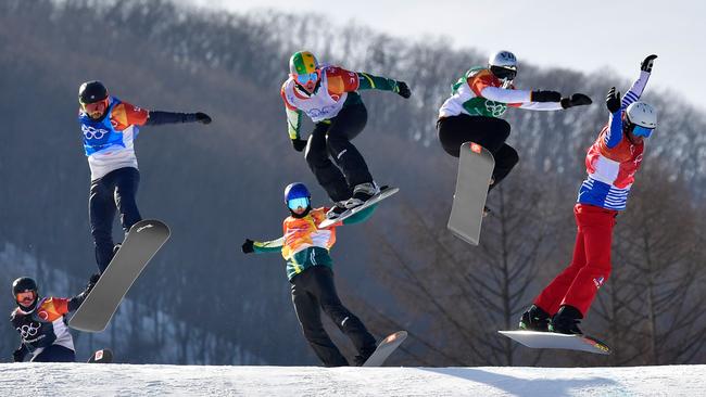 Arch-rivals Jarryd Hughes and Alex Pullin, centre, face off during the men’s snowboard cross final at the PyeongChang Winter Olympic Games on Thursday. Picture: AFP