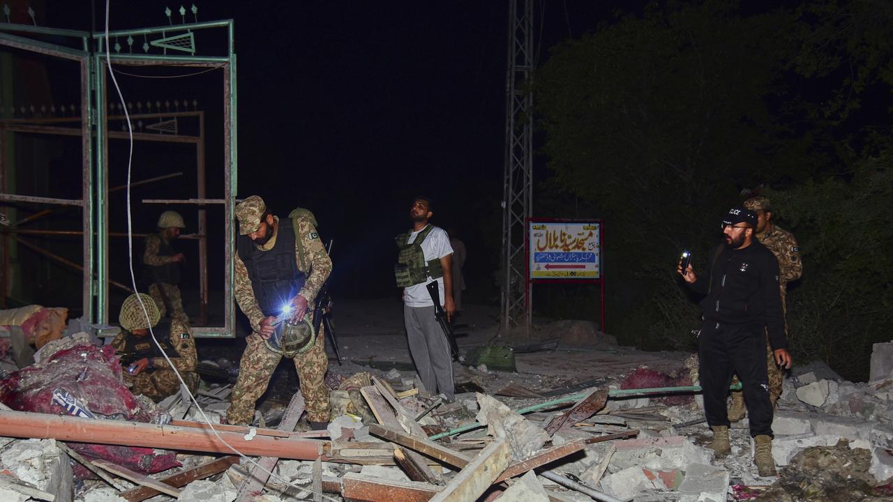 Army soldiers examine a building damaged by a suspected Indian missile attack near Muzaffarabad, the capital of Pakistan controlled Kashmir. Picture: AP Photo/MD Mughal