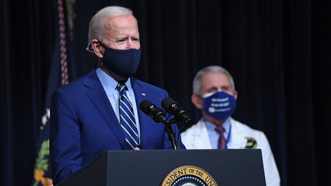 US President Joe Biden speaks, flanked by Mr Fauci, during a coronavirus press conference in 2021.