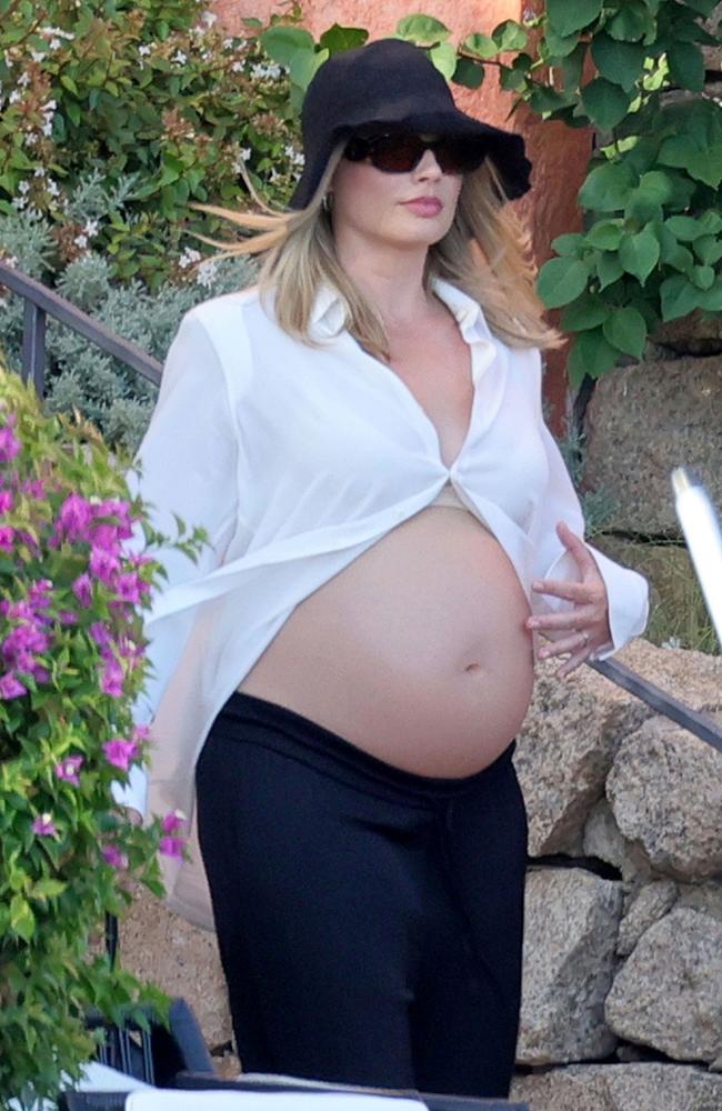 Margot Robbie looked radiant as she showed off her growing baby bump while on vacation in Sardinia on August 26. Picture: CIAOPIX / COBRA TEAM / BACKGRID