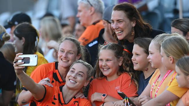 BRISBANE, AUSTRALIA - OCTOBER 21: Kijah Stephenson and Teagan Thompson of Brisbane take selfies with fans during the A-League Women round two match between Brisbane Roar and Sydney FC at Ballymore Stadium, on October 21, 2023, in Brisbane, Australia. (Photo by Albert Perez/Getty Images)