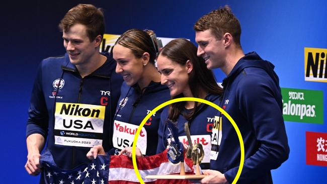 USA team members pose with the best team trophy during the swimming event at the World Aquatics Championships in Fukuoka on July 30, 2023. (Photo by Philip FONG / AFP)`