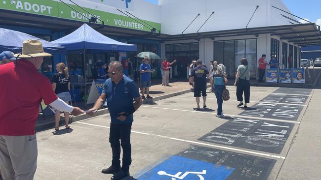 The West End based pre-poll booth in Townsville has limited space. Townsville State MP Scott Stewart hands out how-to-vote cards to voters, but Mr Stewart said he cannot step onto the road or the car park spaces.