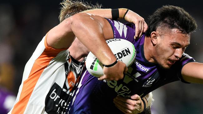 SUNSHINE COAST, AUSTRALIA - SEPTEMBER 19: Tino Faasuamaleaui of the Storm is tackled during the round 19 NRL match between the Melbourne Storm and the Wests Tigers at Sunshine Coast Stadium on September 19, 2020 in Sunshine Coast, Australia. (Photo by Matt Roberts/Getty Images)