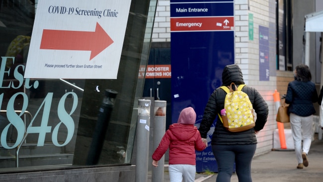 A woman and a child are seen outside The Royal Melbourne Hospital. Picture: NCA NewsWire / Andrew Henshaw