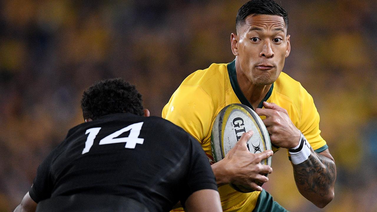 Israel Folau of the Wallabies is tackled by Waisake Naholo of the All Blacks.