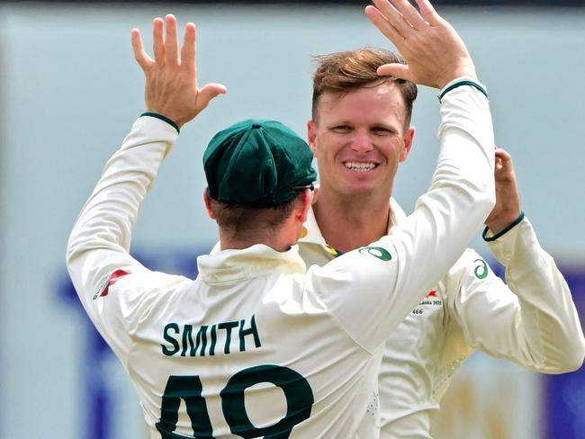 Australia's Matthew Kuhnemann (back) celebrates with his captain Steve Smith after taking the wicket of Sri Lanka's Kamindu Mendis during the fourth day of the first Test cricket match between Sri Lanka and Australia at the Galle International Cricket Stadium in Galle on February 1, 2025. (Photo by Ishara S. KODIKARA / AFP)