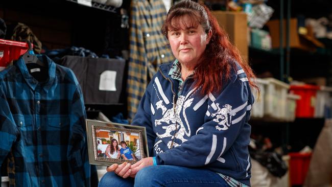 Cathy Cunningham with a photograph of her son, William Cunningham, and surrounded by clothes she delivers to the homeless for the William’s Wardrobe charity established in her son’s honour. Picture: Matt Turner.