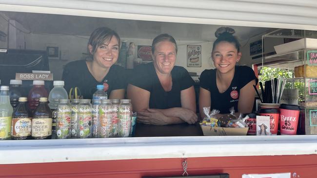 True Davidson, Selena Ewart (owner of Top Spot Cafe at Lakewood and Little Red Van Cafe) and Myanna Mozeley in the coffee and food caravan, situated on Laurieton‘s Bay Side Circuit. Picture: Gemma Ferguson