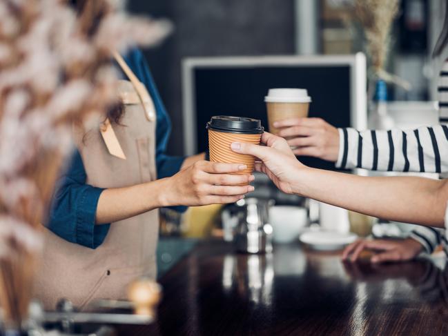 General iStock pics for Best Cafe poll.  Barista served take away hot coffee cup to customer at counter bar in cafe restaurant,coffee shop business owner concept,Service mind waitress. Picture: iStock