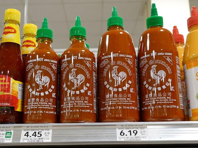 MIAMI, FLORIDA - MAY 10: Bottles of Huy Fong Foods Sriracha line a grocery store shelf on May 10, 2024 in Miami, Florida. Huy Fong Foods, a leading sriracha maker, is warning that a shortage is possible because they had to halt production due to jalapeÃ±o chili peppers not being red enough.   Joe Raedle/Getty Images/AFP (Photo by JOE RAEDLE / GETTY IMAGES NORTH AMERICA / Getty Images via AFP)