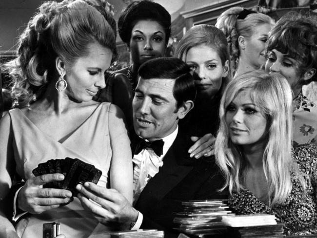 Flanked by Bond girls, George Lazenby, centre, played the seductive spy in On Her Majesty's Secret Service.