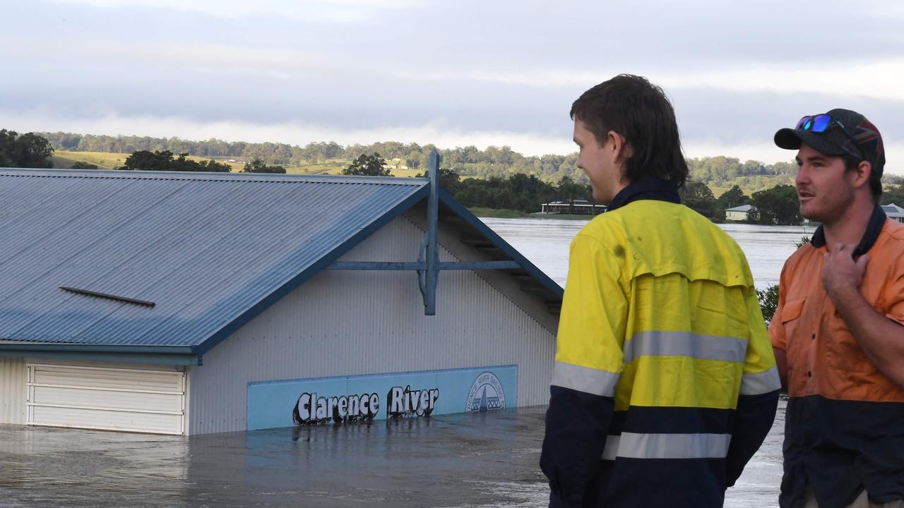 Workers watch a flooded shed at the bank of over flowing Clarence River in Grafton, some 130 kms from the New South Wales town Lismore on, March 1, 2022. Picture: SAEED KHAN / AFP