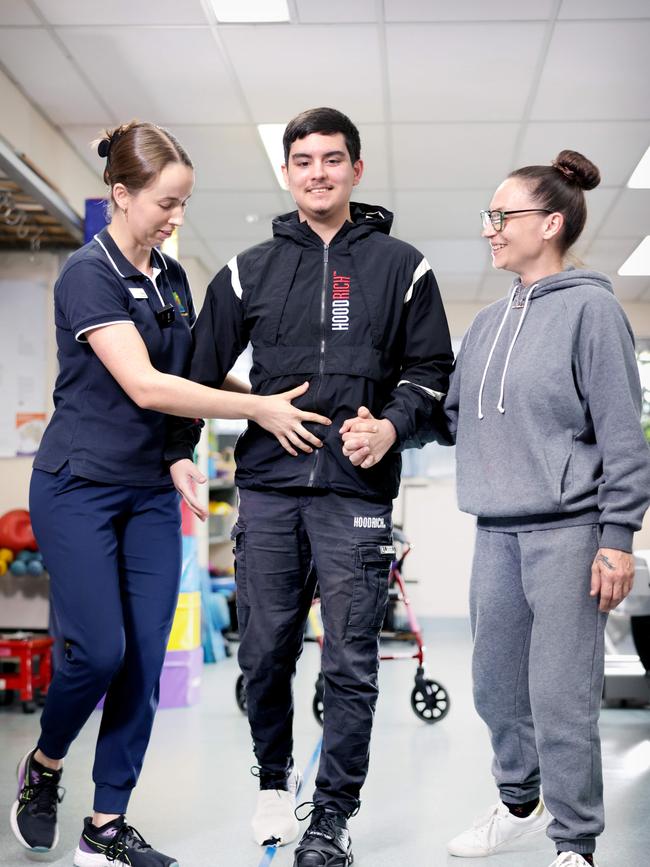 L to R, Physiotherapist Meg Ingram, Paxton 17yrs and Natalie Zocaro (mum). Photo: Steve Pohlner