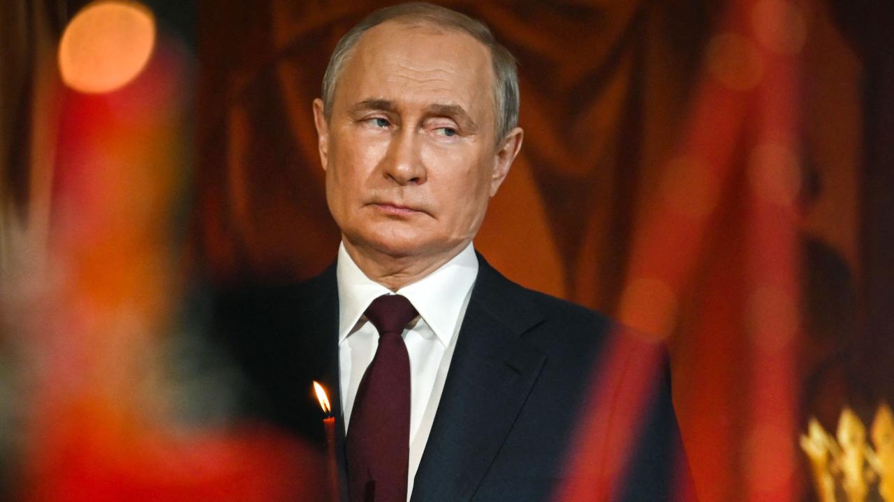 Russian President Vladimir Putin holds a candle during an Orthodox Easter service. Picture: AFP