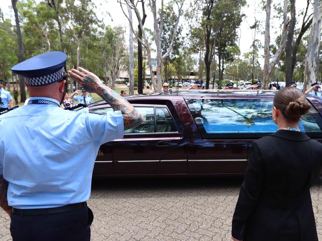 A hearse passes the guard of honour at the memorial service with full police honours for constables Rachel McCrow and Matthew Arnold at Brisbane Entertainment Centre. Picture: David Clark
