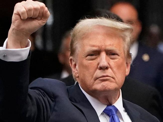 TOPSHOT - Former US President and Republican presidential candidate Donald Trump holds up a fist as he arrives back at Trump Tower after being convicted in his criminal trial in New York City, on May 30, 2024. A panel of 12 New Yorkers were unanimous in their determination that Donald Trump is guilty as charged -- but for the impact on his election prospects, the jury is still out. The Republican billionaire was convicted of all 34 charges in New York on May 30, 2024, and now finds himself bidding for a second presidential term unsure if he'll be spending 2025 in the Oval Office, on probation or in jail. (Photo by TIMOTHY A. CLARY / AFP)