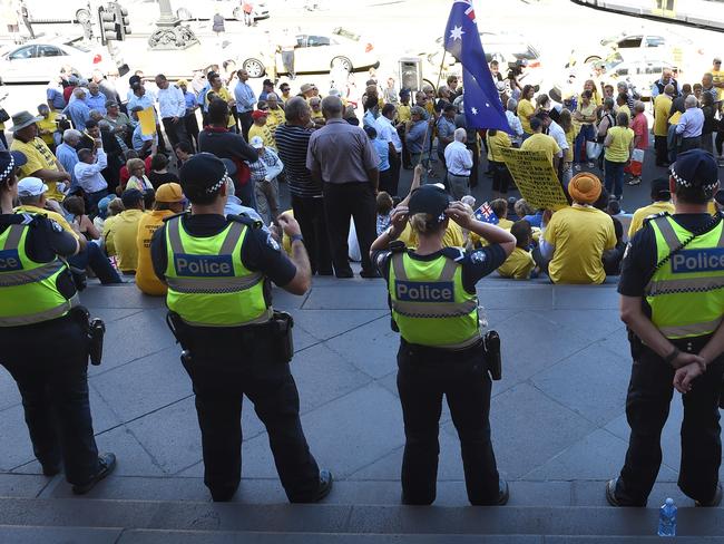 Police stand guard on the steps oft Parliament. Picture: Nicole Garmston
