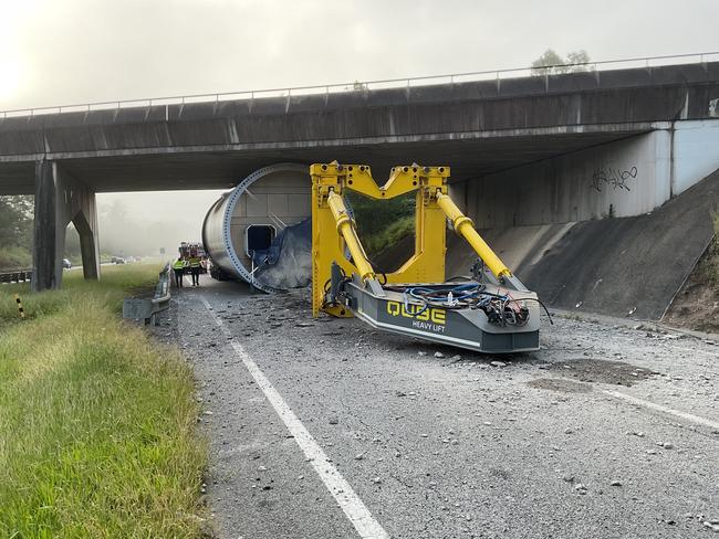 The westbound lanes of the Warrego Highway and all lanes of the Mount Crosby Road overpass at Tivoli are closed due to a bridge strike due to a truck carrying a section of a wind turbine hitting the bridge. TMR crews are on site undertaking structural inspections to determine the extent of the damage. Safety is our priority, and the road will only be reopened after these thorough bridge inspections are complete, and it is safe to do so. Long delays are expected, and road users are encouraged to check  QLDTraffic before undertaking any travel. Picture TMR