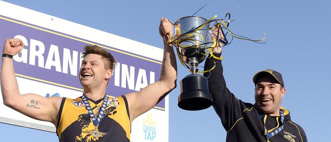 Andrew Fairchild hoists the premiership cup with Whittlesea coach Brad Dean in 2015. Picture: Josie Hayden