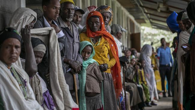 Hundreds of people wait to be assessed by medical workers to see if they have the serious eye disease trachoma. Picture: Michael Amendolia/Fred Hollows Foundation