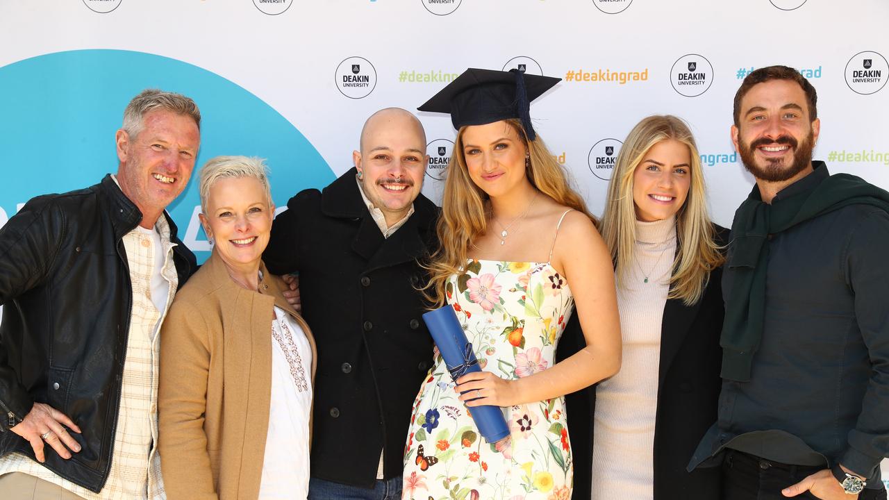 Deakin University graduate Sasha Grant with parents Philip and Karen, partner Alex Jenkins, and siblings Samantha and Ryan. Picture: Alison Wynd