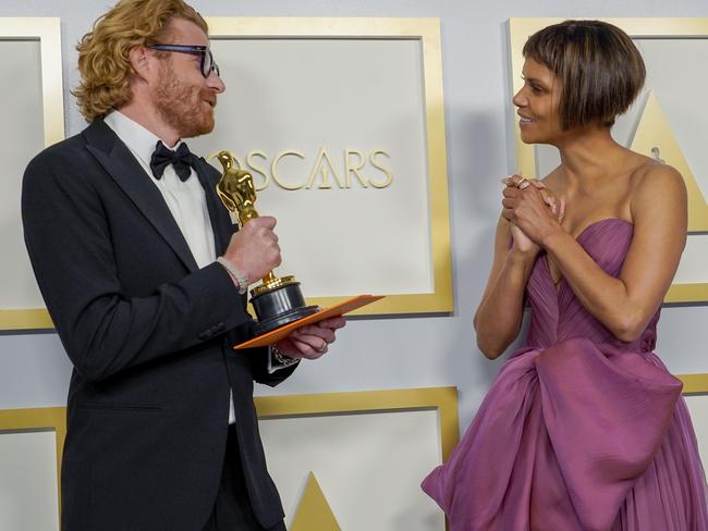 A BTS moment between Erik Messerschmidt, winner of Best Cinematography, and Halle Berry. Picture: AFP